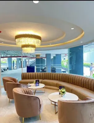 a lobby with a couch and tables and a chandelier at Luxury Condo The City Phuket in Heart of Phuket in Kathu