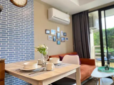 a dining room table with hats and plates on it at Rawai Beach - 1 BR Cozy Condo in Nai Harn Beach