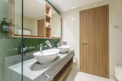a bathroom with two sinks and a mirror at Laguna Beachfront 3BR Cozy Condo in Bang Tao Beach