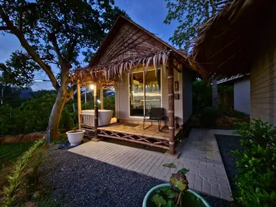 a small house with a porch with a deck at Krabi Sea View Orchid Beach room in Krabi town