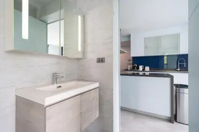 a white kitchen with a sink and a counter at Bangtao Beach Garden - 2 BR Apartment in Surin Beach