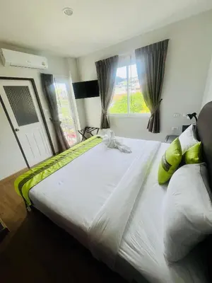 a large white bed in a room with a window at 28 Boutique Hotel - Newly Renovated in Patong Beach