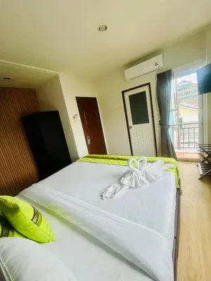 a bedroom with two beds with white bows on them at 28 Boutique Hotel - Newly Renovated in Patong Beach