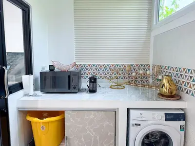a kitchen with a counter with a washing machine at Townhouse Bellano 3BR FamilyLaguna Park Bang Tao in Laguna Phuket