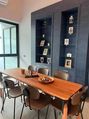 a dining room with a wooden table and chairs at The Granary Villas by SP in Ban Pak Lak