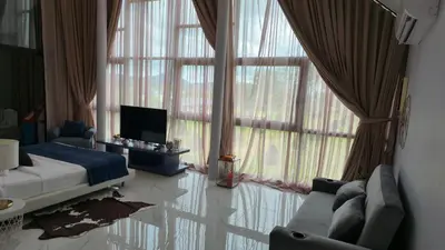 a bedroom with a bed and a tv and large windows at The Granary Villas by SP in Ban Pak Lak