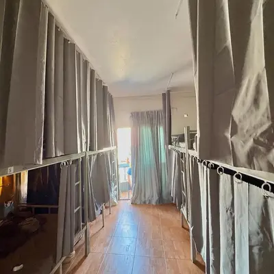 a room with curtains and a room with a fireplace at Sundiva Guest House in Patong Beach
