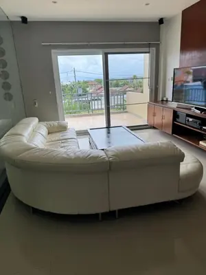 a white couch in a living room with a large window at Rawai Seaview Pool Townhouse in Rawai Beach