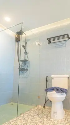 a bathroom with a toilet and a glass shower at Jaokhun Hilltop Patong, Phuket in Patong Beach