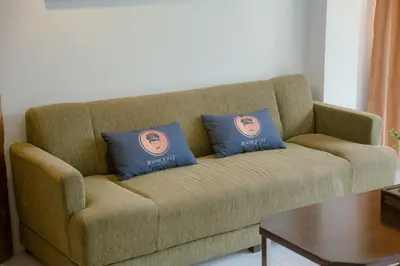 two pillows on a couch in a living room at RQ Phuket Kalim Beach Blue Horizon in Patong Beach