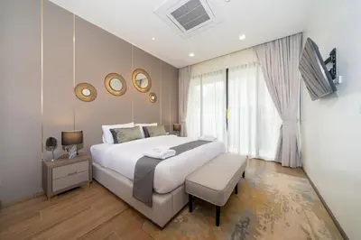 a bedroom with a large white bed and a window at The Exclusive Sky D1 \u8c6a\u534e4\u5367\u5ba4\u6d77\u666f\u522b\u5885 \u79c1\u4eba12m\u65e0\u8fb9\u6d77\u666f\u6cf3\u6c60 \u6bcf\u65e5\u6e05\u6d01 in Kamala Beach