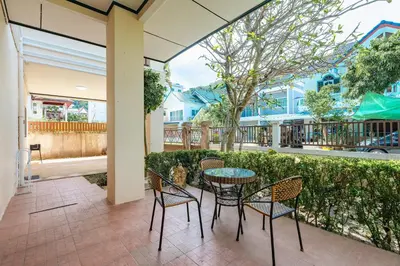 a patio with a table and chairs and a fence at Tranquility Haven Villa, Kata Beach in Kata Beach