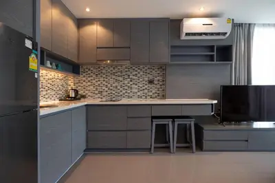 a kitchen with gray cabinets and a counter top at Tropical Kamala Hill View 1 BR CTG P407 in Kamala Beach
