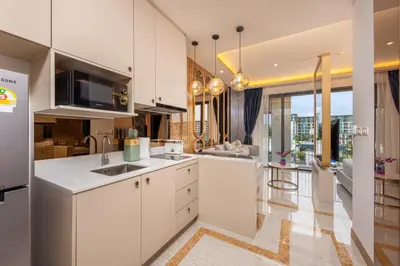 a kitchen with white cabinets and a large window at Bellevue Lagoon Premium Apart Hotel by TropicLook in Bang Tao Beach
