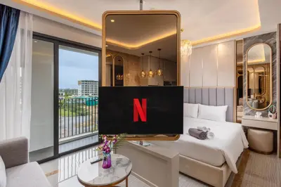 a hotel room with a tv with the letter n on it at Bellevue Lagoon Premium Apart Hotel by TropicLook in Bang Tao Beach