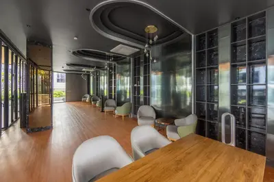 a conference room with a wooden table and chairs at Bellevue Lagoon Premium Apart Hotel by TropicLook in Bang Tao Beach