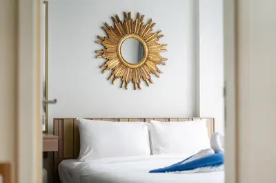 a mirror above a bed in a bedroom at Holiday apartment at The Deck by Lofty in Patong Beach