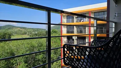 a balcony with a view of a building at Квартира in Ban Mai Salae