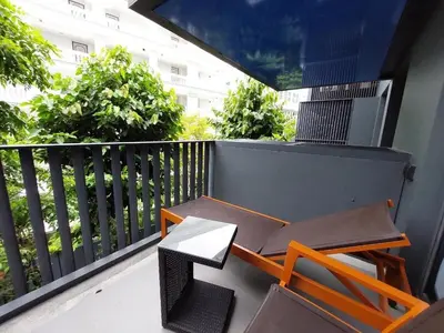 a balcony with a table and a chair on it at The Deck Patong in Patong Beach