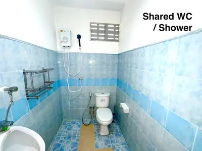 a blue tiled bathroom with a toilet and a sink at Patong Canal House 1 in Patong Beach