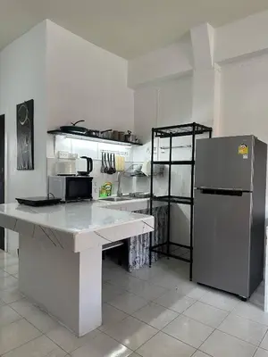 a kitchen with a counter and a refrigerator at Bestin Karon1 - 1 min from the beach, pet friendly TF in Karon Beach