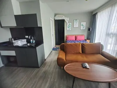a living room with a couch and a table at The Deck Condo Patong Mountain View1 in Patong Beach