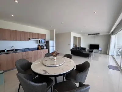 a kitchen and living room with a table and chairs at Sunset Plaza Karon Seaview in Karon Beach