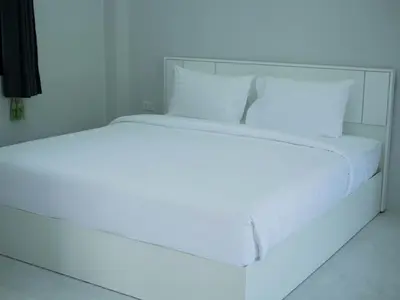 a white bed with a light on top of it at Borrii House โบ ลี่ เฮาท์ in Layan Beach
