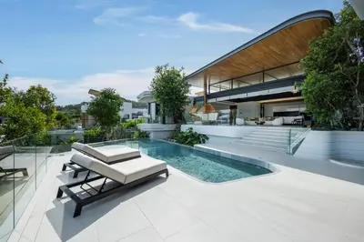 an exterior view of a house with a swimming pool at Villa Zavaya 360° View Luxury Retreat With Pool in Layan Beach