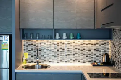 a kitchen with a sink and blue cabinets at Tropical Kamala Pool View 1 BR CTG B206 in Kamala Beach