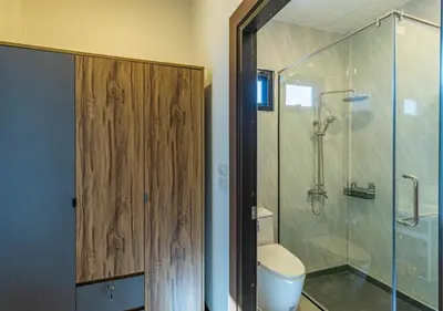 a bathroom with a toilet and a glass shower at Villa Junia - Quiet 3-bedroom Pool Villa in Ban Saiyuan (1)