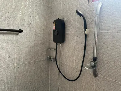 a phone in a shower in a bathroom at Nankanok Resort in Ko Yao Noi