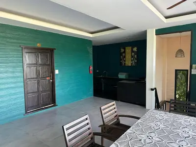 a dining room with blue walls and a table and chairs at Nankanok Resort in Ko Yao Noi