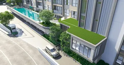 a car parked in front of a building with a grass roof at Space Cherngtalay Condo in Elegant Bang Tao in Ban Thalat Choeng Thale