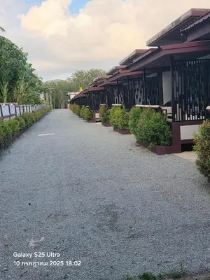 an empty road in front of a building at Resort Thalang in Phuket