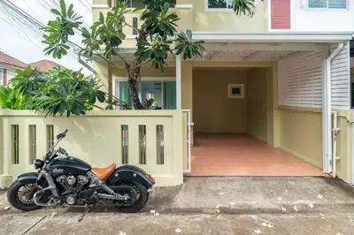a motorcycle parked in front of a house at OldTown Home Phuket 3min walk Central Festival in Ban Rangeng
