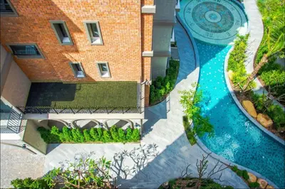 an aerial view of a swimming pool in front of a building at 1 br Cozy Orchid at The Title Nai Yang in Nai Yang Beach
