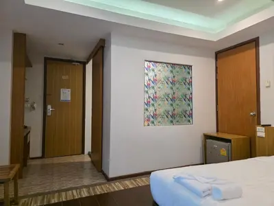 a bedroom with a bed and a painting on the wall at Le Moon in Patong Beach