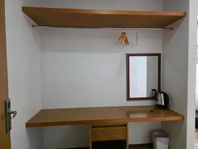 a mirror on a wall next to a desk at Le Moon in Patong Beach