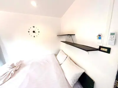 a bedroom with a bed and a clock on the wall at Patong Canal Villa 305 in Patong Beach