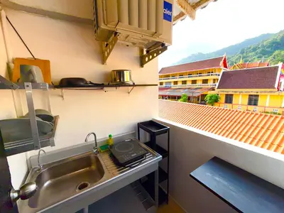 a kitchen with a sink and a view of a building at Patong Canal Villa 305 in Patong Beach