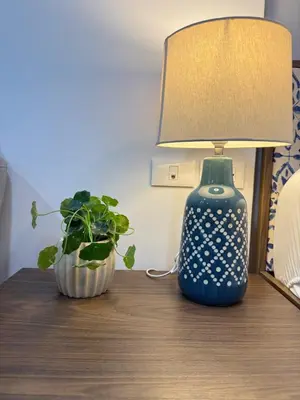 a lamp and a plant on a table at Luxury Resort Style 1 Bedroom Studio near Central in Phuket Town