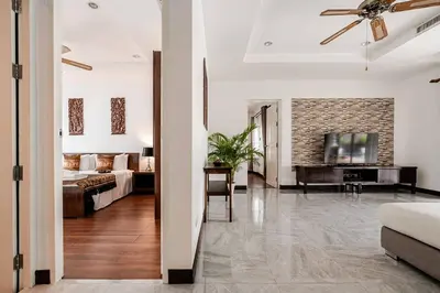 a living room with a couch and a tv at Cozy Pool Villa near Kamala - 12 min to the Beach in Kamala Beach