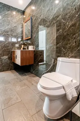 a bathroom with a toilet and a sink and a mirror at Cozy Pool Villa near Kamala - 12 min to the Beach in Kamala Beach
