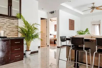 a kitchen and living room with a table and chairs at Cozy Pool Villa near Kamala - 12 min to the Beach in Kamala Beach
