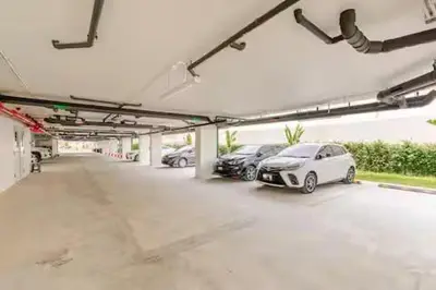 a parking garage with several cars parked in it at Чудесная видовая квартира Fantasea пляж Камала in Kamala Beach