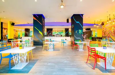a restaurant with tables and chairs in a cafeteria at Cassia Phuket, part of Banyan Group in Bang Tao Beach
