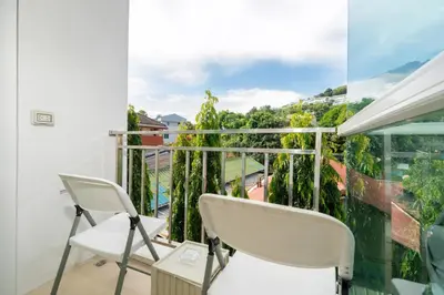 a balcony with two chairs and a view at Mountain view apartment near Kata beach in Kata Beach