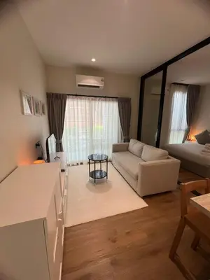 a living room with a couch and a table at Title Halo Nai Yang Тайтл Хало Най Янг operated by OK Group in Nai Yang Beach