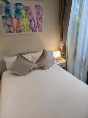 a white bed with four pillows in a bedroom at Title Halo Nai Yang Тайтл Хало Най Янг operated by OK Group in Nai Yang Beach
